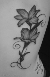 Black and white photo image of floral back tattoo