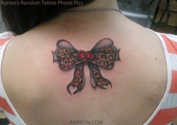 cheetah print with heart button tattoo